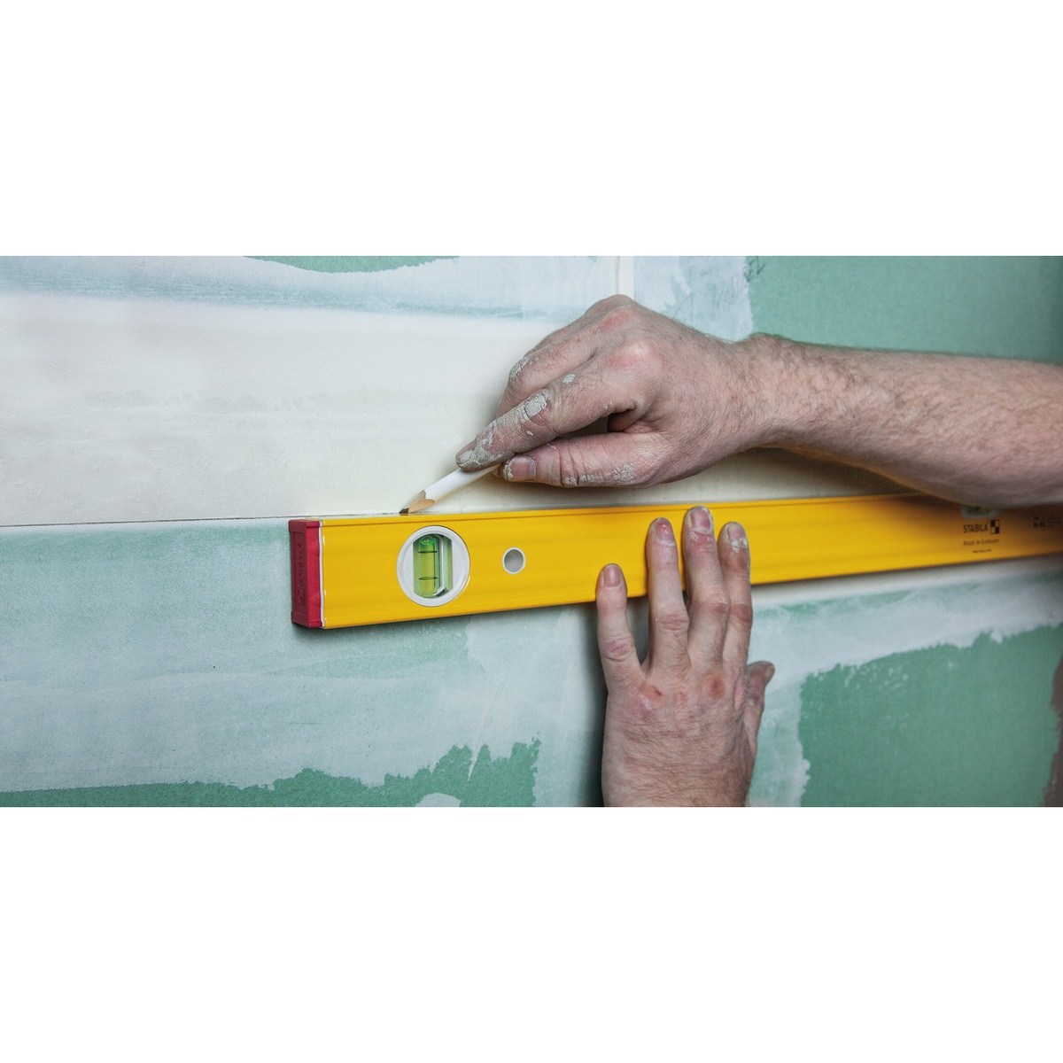 Stabila 29840 PRO SET 80 AS Spirit Levels being used to mark a level line on a drywall wall during interior layout work