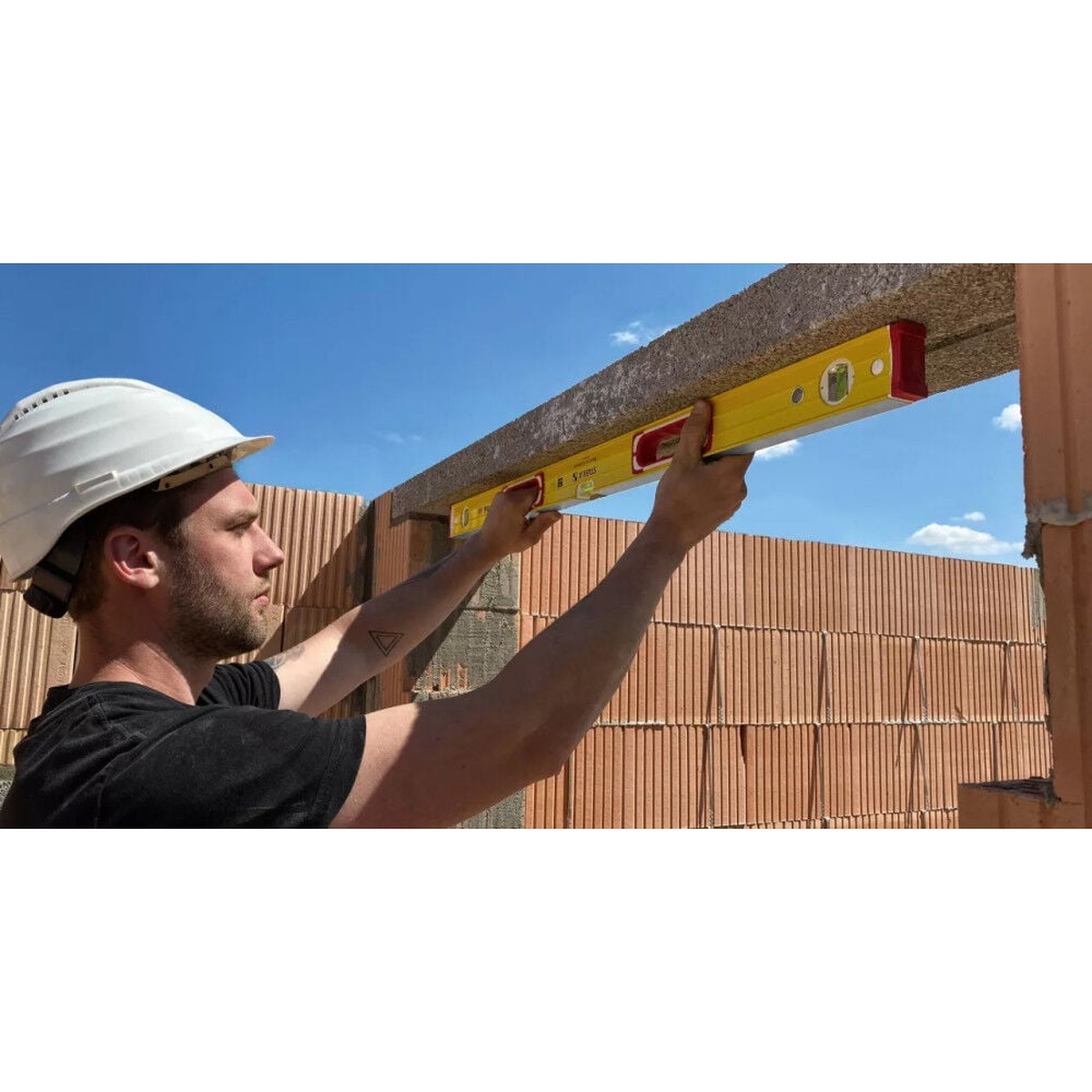 Stabila 78296 level set spirit level being used to check a masonry header opening on a construction site