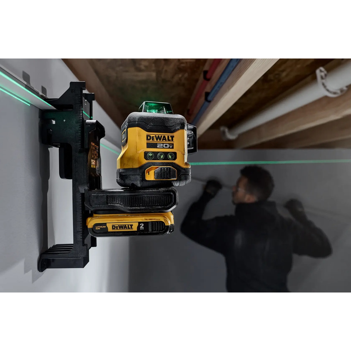 DEWALT DCLE34031D1 20V 3x360 Green Line Laser Kit mounted on a wall bracket projecting green layout lines in an interior room during framing and installation work