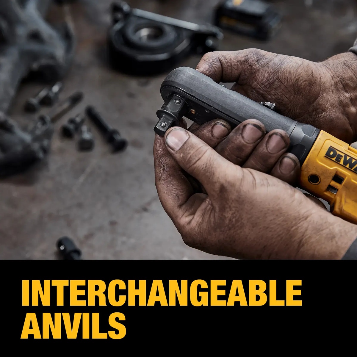 DEWALT DCF510B cordless ratchet with interchangeable anvil being swapped by hand at a workbench during automotive fastening work