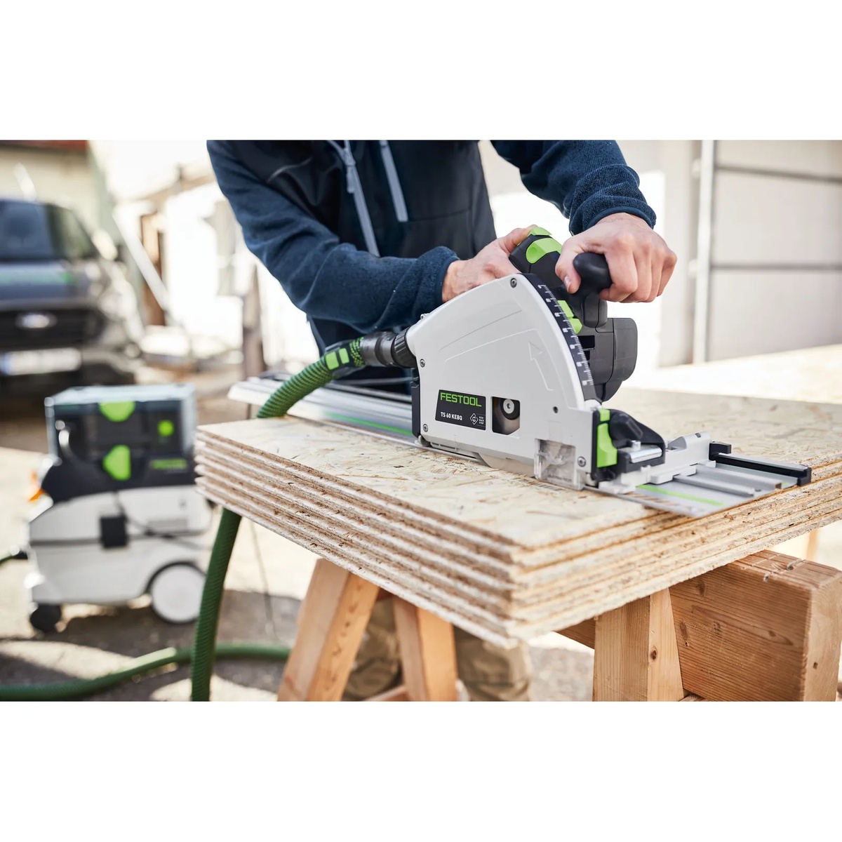 Festool 205771 HW 168x1,8x20 W28 168mm 28T Universal Wood Saw Blade installed in a Festool plunge saw cutting stacked sheet goods on a jobsite work table