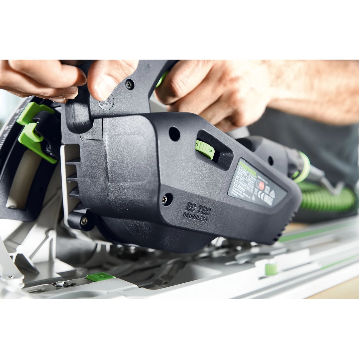 Close-up of the Festool TS 60 KEB-F-Plus brushless EC-TEC motor housing while the track saw is set on a guide rail during cutting setup