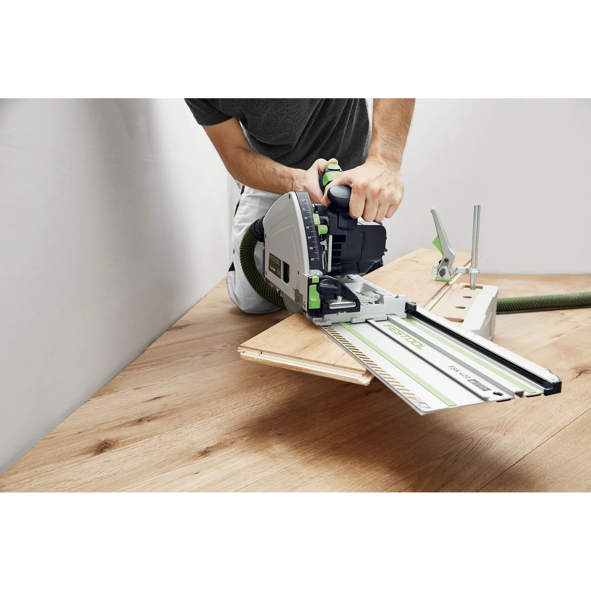 Festool 576726 TS 60 KEB-F-Plus Plunge Cut Track Saw Set making a guided cut on plywood flooring material with a Festool rail in an indoor jobsite setup