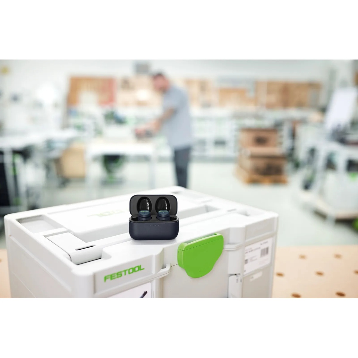 Festool GHS 25 I hearing protection earplugs in charging case on a Festool Systainer in a workshop, showing compact jobsite-ready hearing protection between tasks