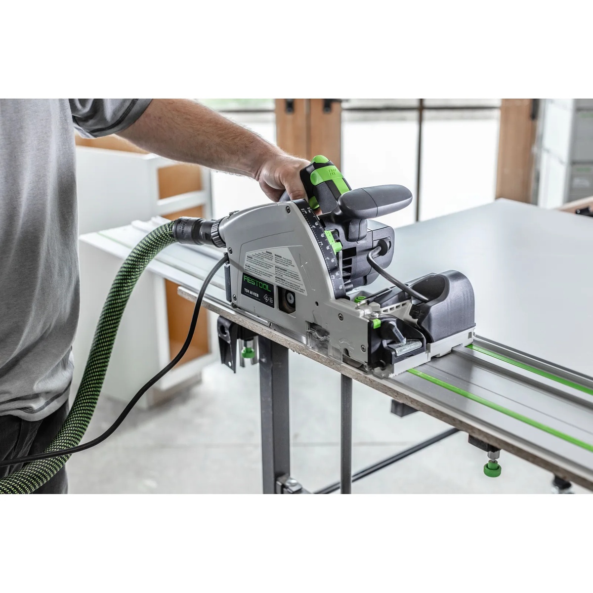 Operator using Festool TSV 60 KEB-Plus Plunge Cut Scoring Track Saw Set on a guide rail for precise sheet cutting