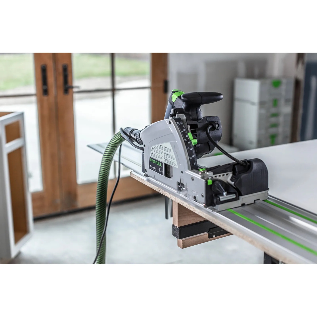 Festool TSV 60 KEB-Plus Plunge Cut Scoring Track Saw Set cutting a panel on a guide rail in a cabinet shop setting