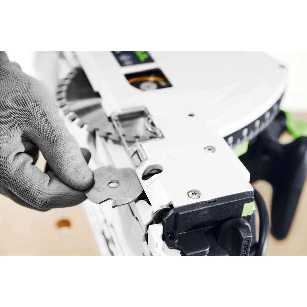 Close-up of the Festool plunge cut scoring track saw adjustment area during setup on a workbench before a precision cut