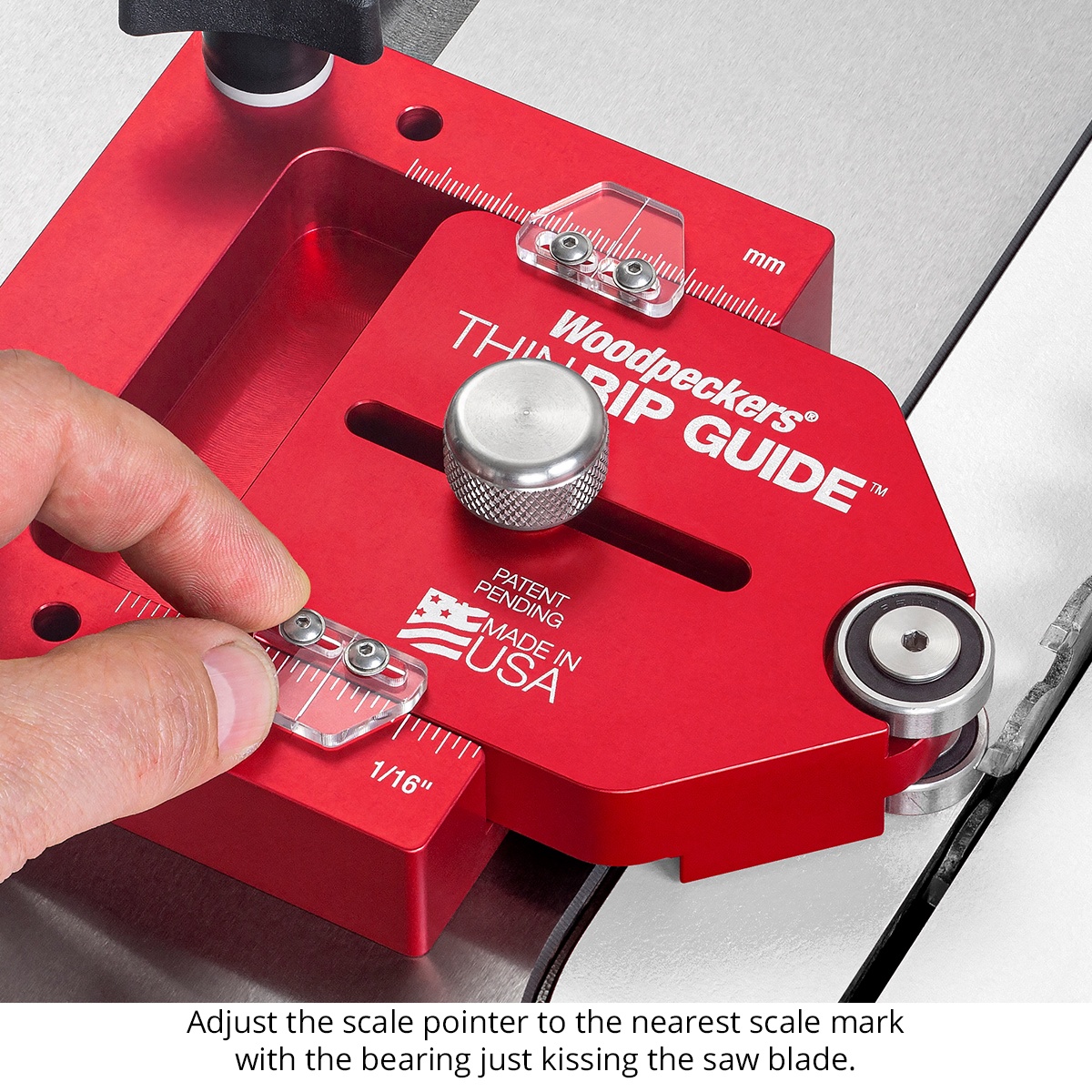 Close-up of the Woodpeckers ThinRip Guide w/ Rack-It adjustment scale and pointer being set beside a table saw blade for thin ripping