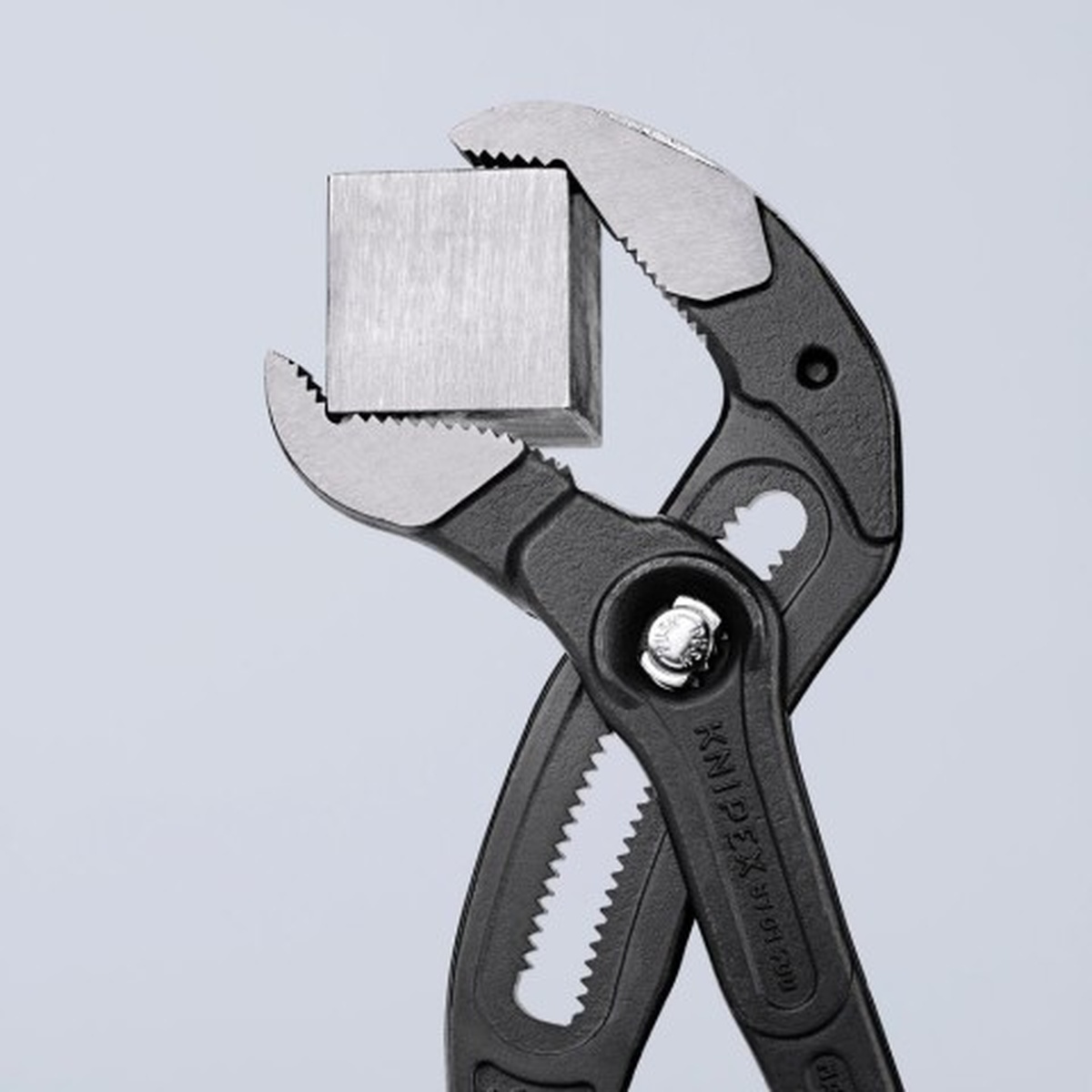 Knipex 87 01 400 US Cobra XL Water Pump Pliers adjusted around square stock to show fine jaw positioning for gripping different material shapes