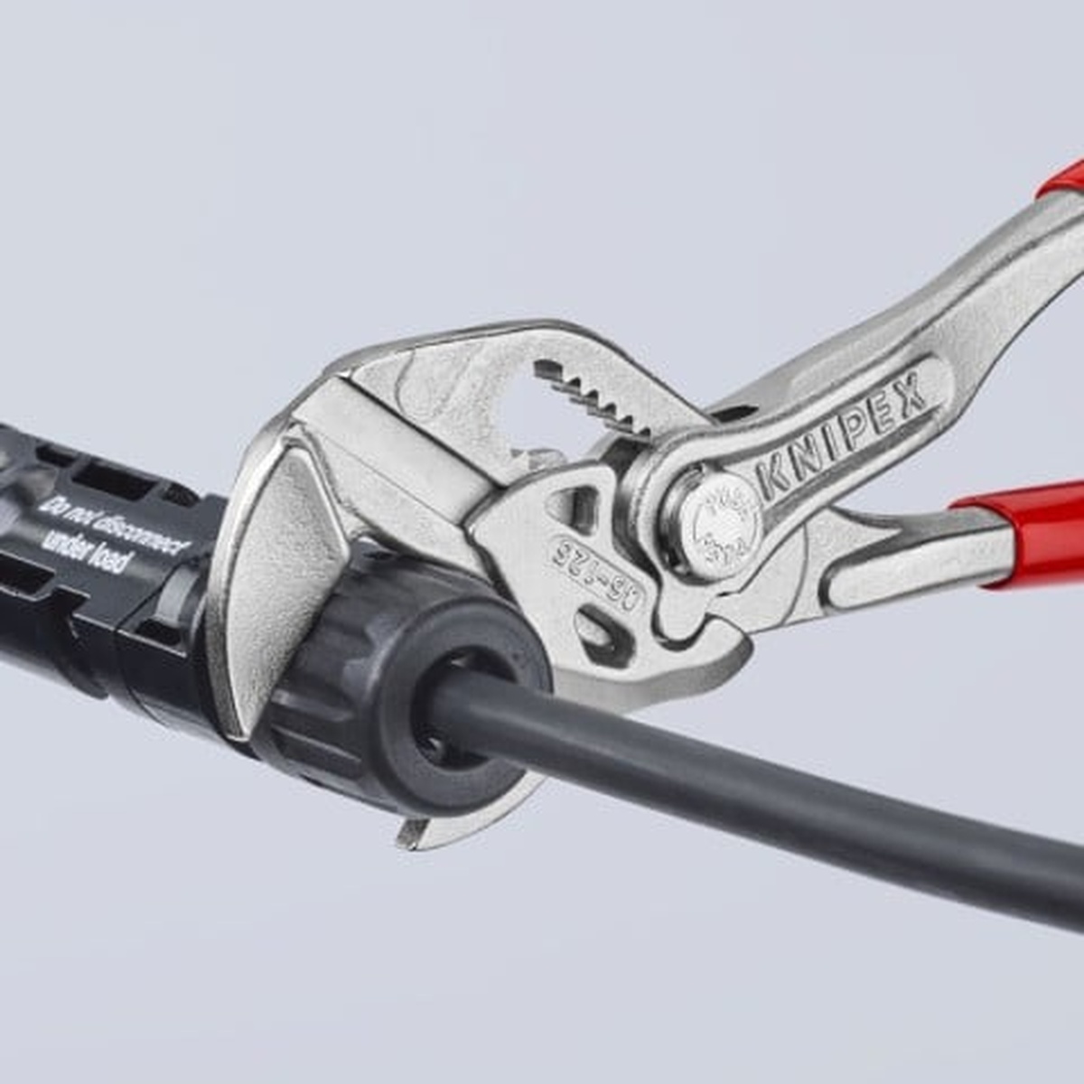 Knipex 9K 00 80 121 US 2 Pc Mini Pliers Wrench Set gripping a cable fitting in a tight service area during fastening work
