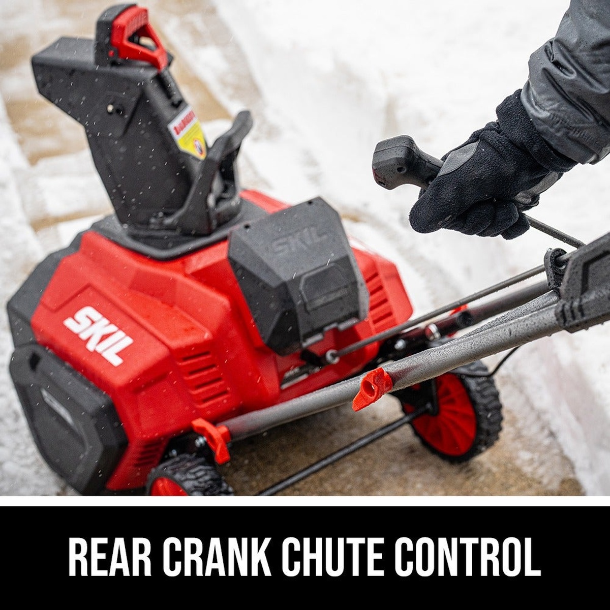 SKIL 40V Brushless 20 In. Single Stage Snow Blower Kit rear crank chute control being adjusted by the operator beside a snow-covered walkway