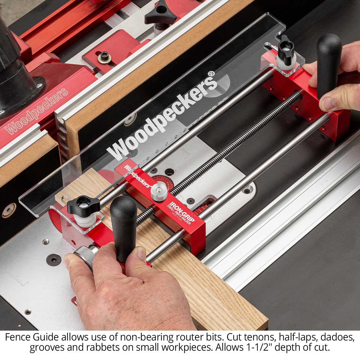 Woodpeckers Iron-Grip Small Parts Holder routing a wood board against a fence guide with a non-bearing router bit on a router table