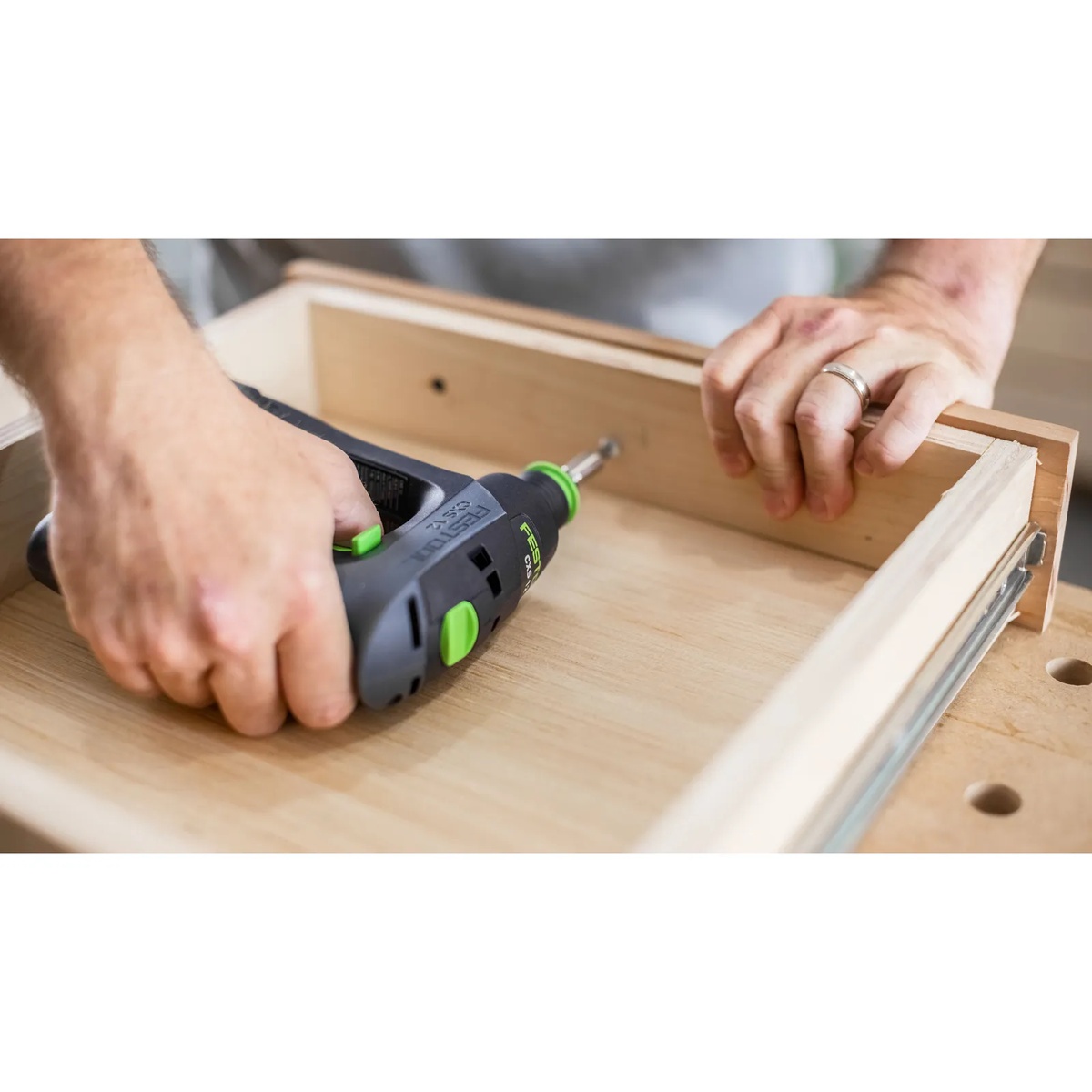 Festool CXS 12 2.5Ah Cordless Drill Kit being used inside a drawer box for fastening in a tight interior corner