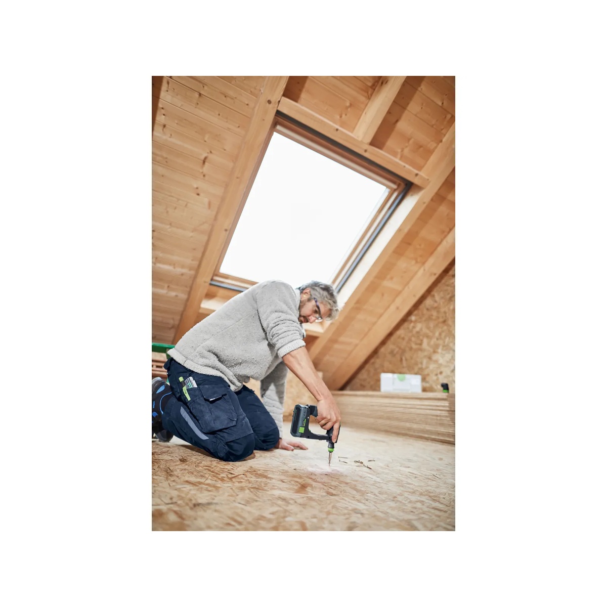 Festool 576887 CXS 18 BASIC Cordless Drill driving screws into a wood subfloor on a residential interior build