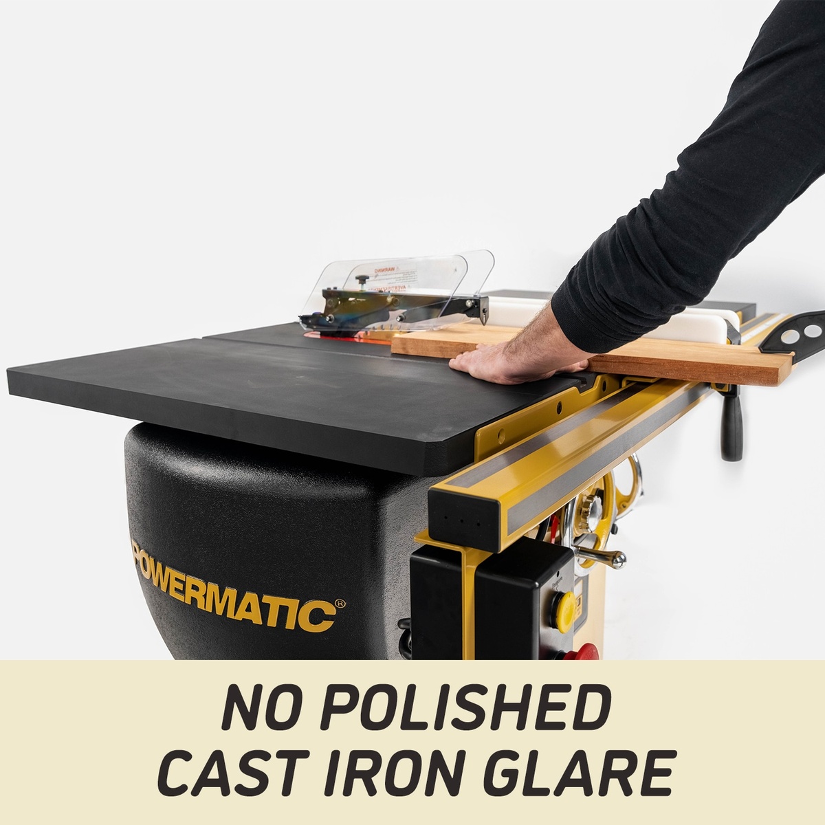 Powermatic PM25150RKT Table Saw cutting a wood board across the ArmorGlide cast iron table in a workshop-style setup