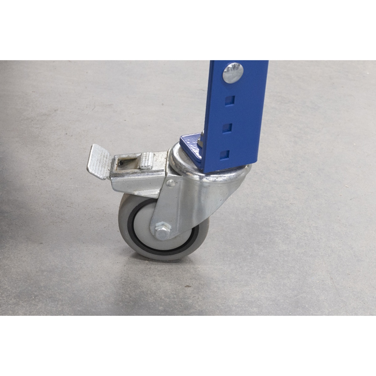 Kreg Tool UBENCH-6824-DH workbench caster close-up showing foot-operated wheel lock for stable shop positioning on a concrete floor