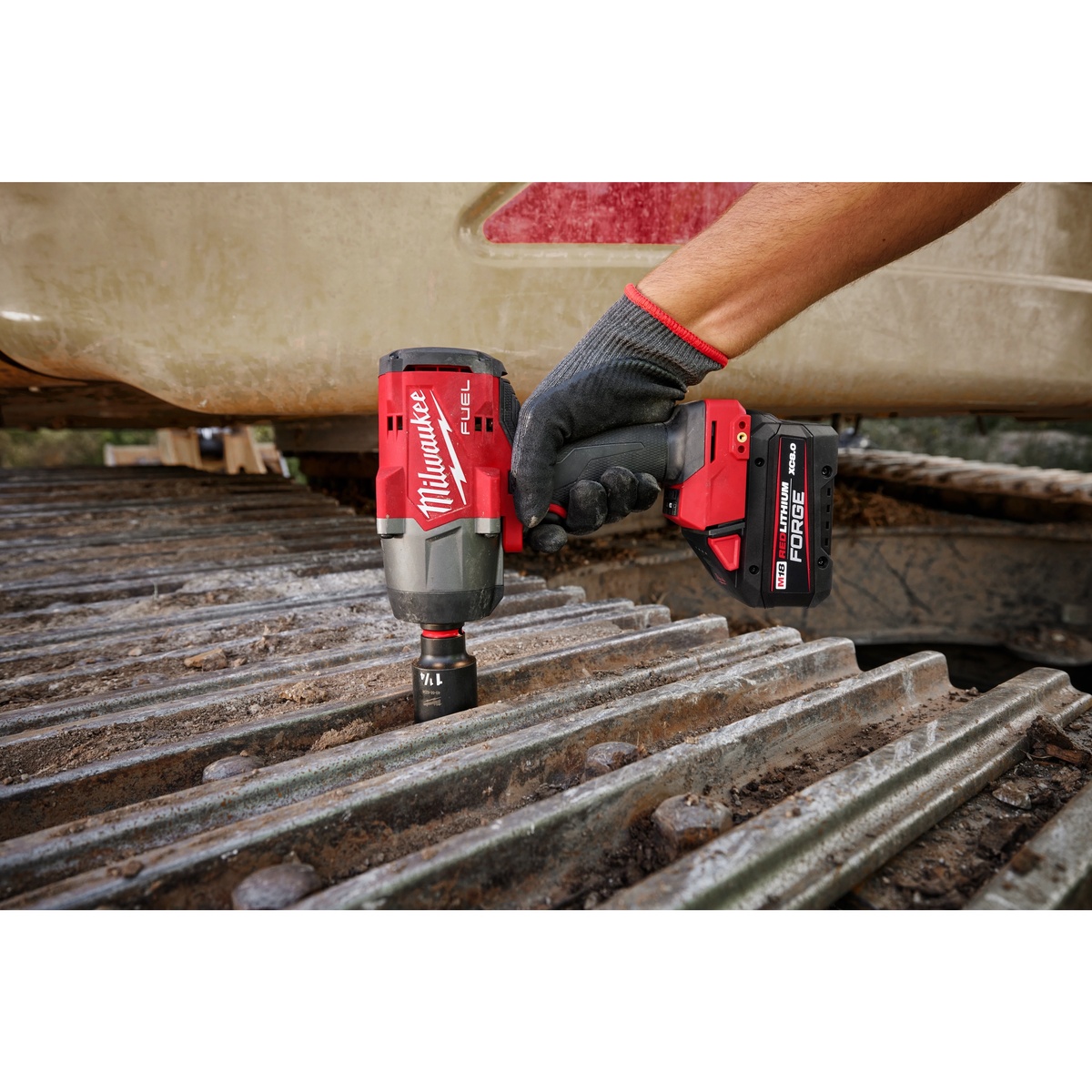 Milwaukee 2967-20 M18 FUEL 1/2 in High Torque Impact Wrench with Friction Ring removing a heavy fastener on metal equipment in a real service environment
