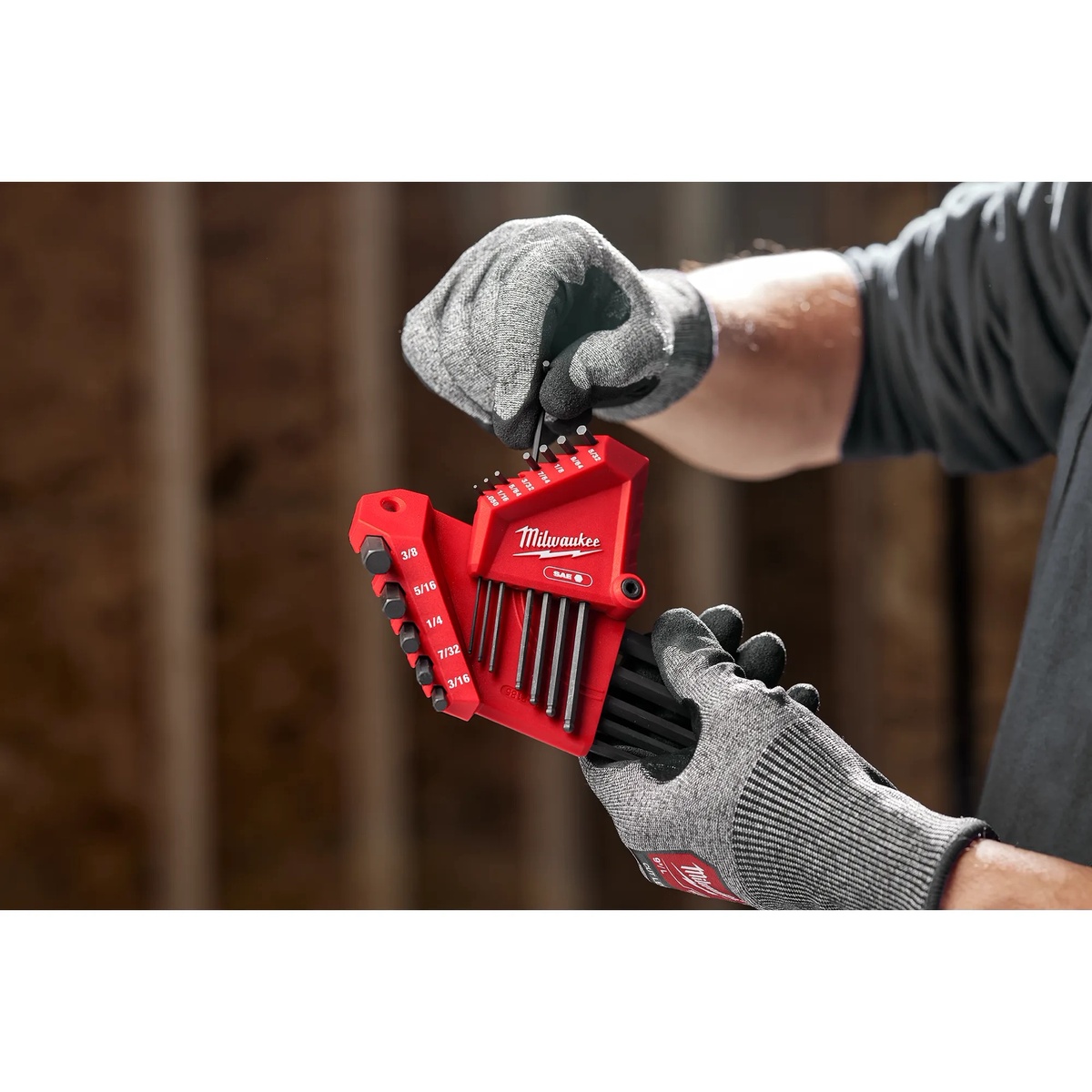 Milwaukee 48-22-2187 22-Key Ball End L-Key Set - SAE/Metric with pivoting holder being opened by a gloved user at a workbench for fast hex key size selection