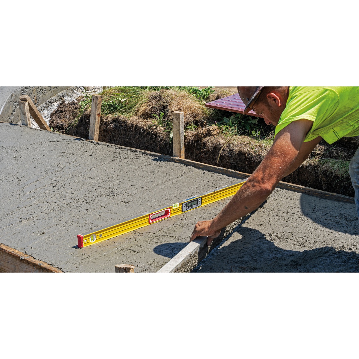 Stabila TECH 196 DL electronic level being used on wet concrete during slab and form work on a jobsite