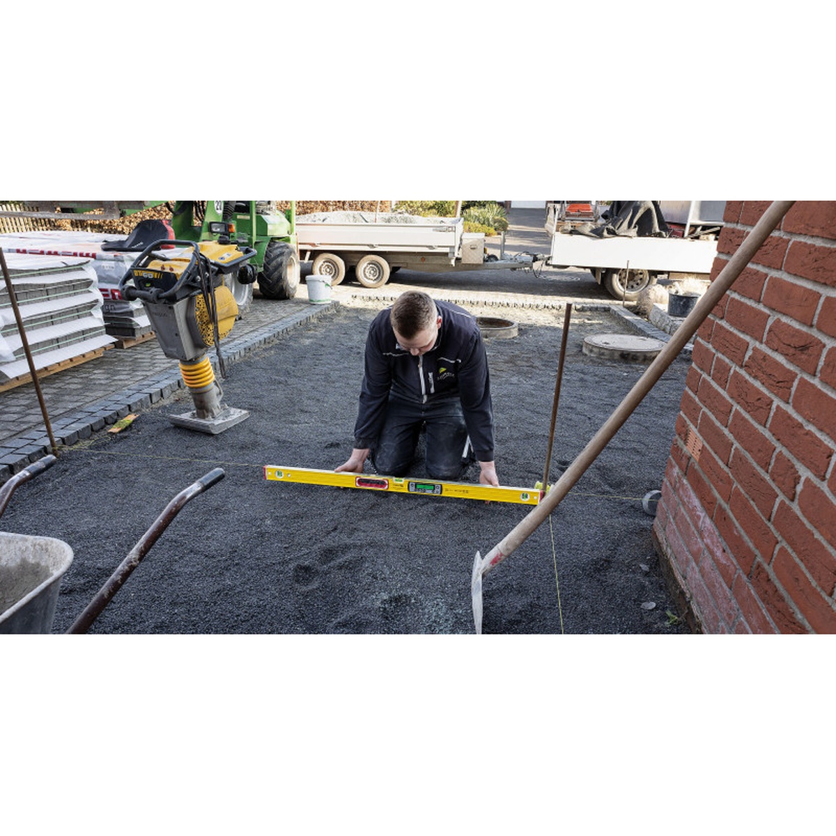 Stabila 39577 TECH 196 DL 72 inch digital spirit level checking grade on compacted base at a jobsite