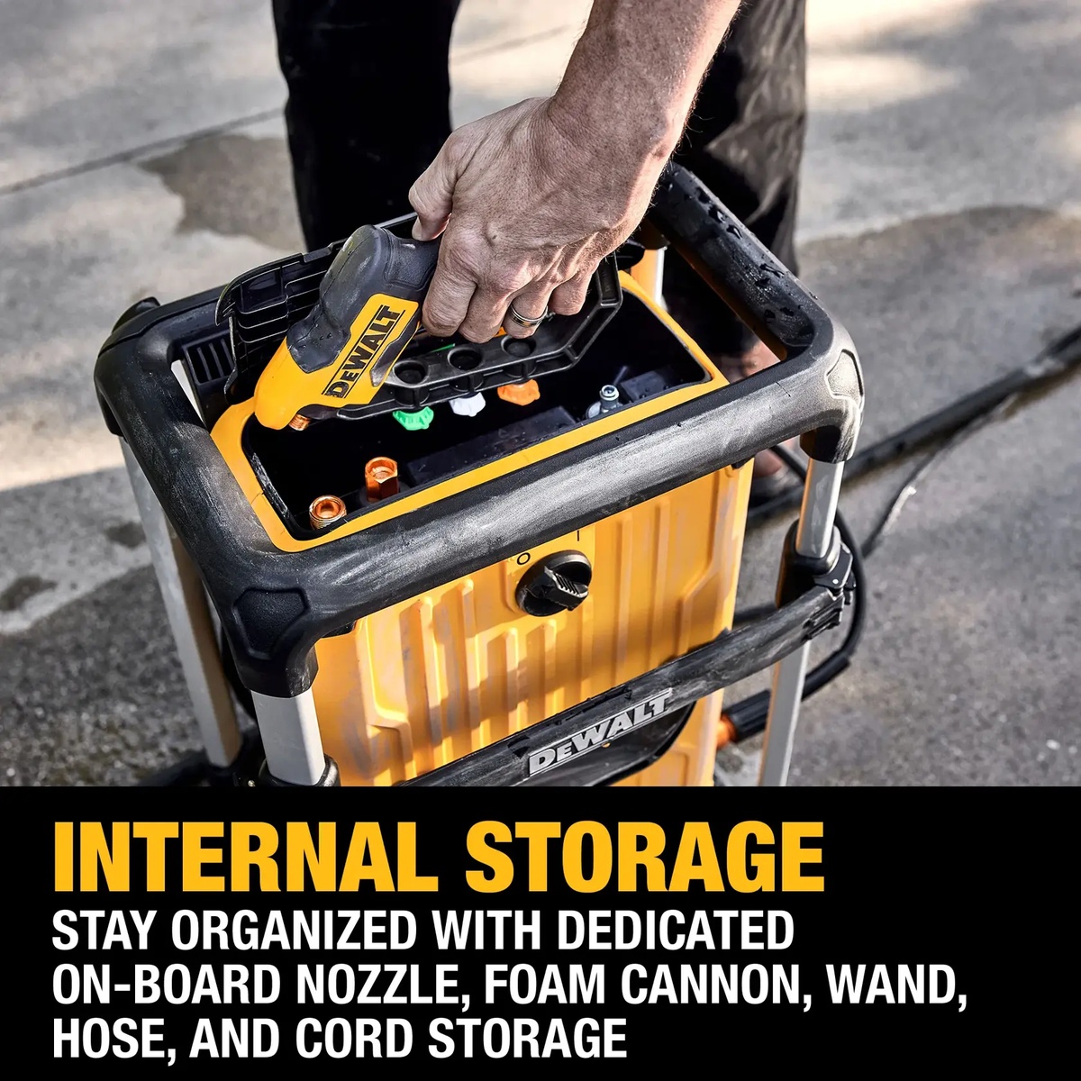 DEWALT jobsite pressure washer with onboard nozzle and wand storage during setup on a driveway