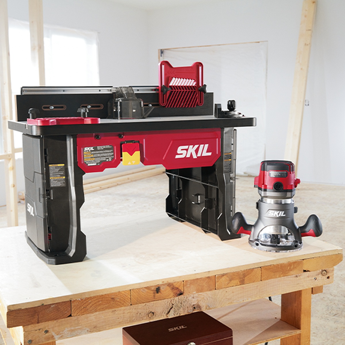 SKIL RT1323-01 Router Table and Fixed Base Router Kit set up on a woodworking bench in a shop space, showing the router table and fixed base router ready for edge routing and joinery work