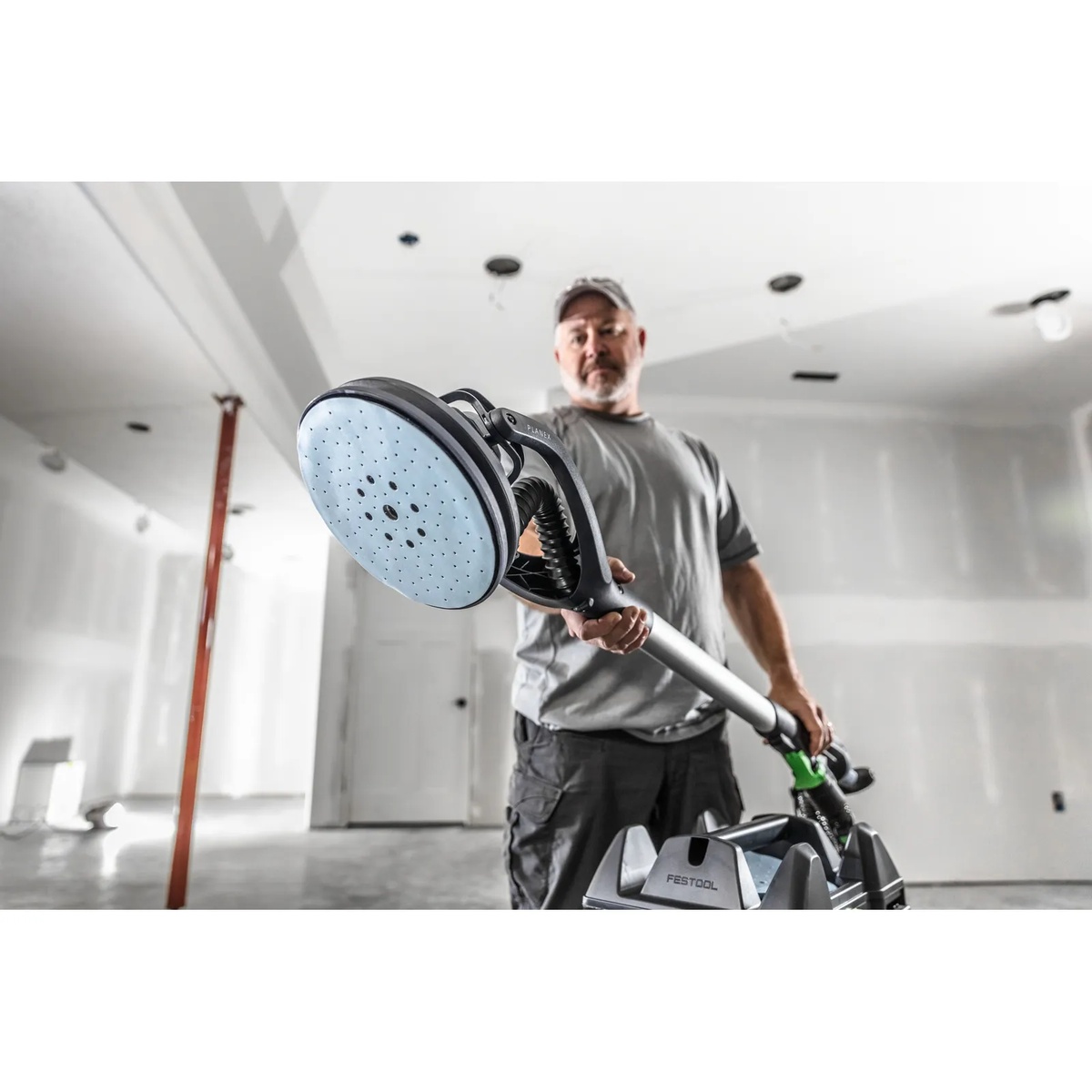 Festool 577359 PLANEX LHS 2-M 225 EQ Long-Reach Sander abrasive pad close-up in a drywall finishing room