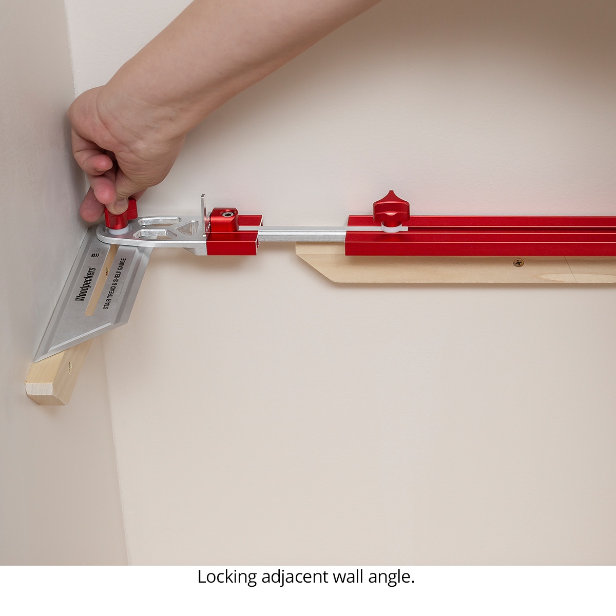 Woodpeckers Stair Tread & Shelf Gauge locking against an inside wall corner to capture the exact angle for shelf or stair tread fitting in a finished room