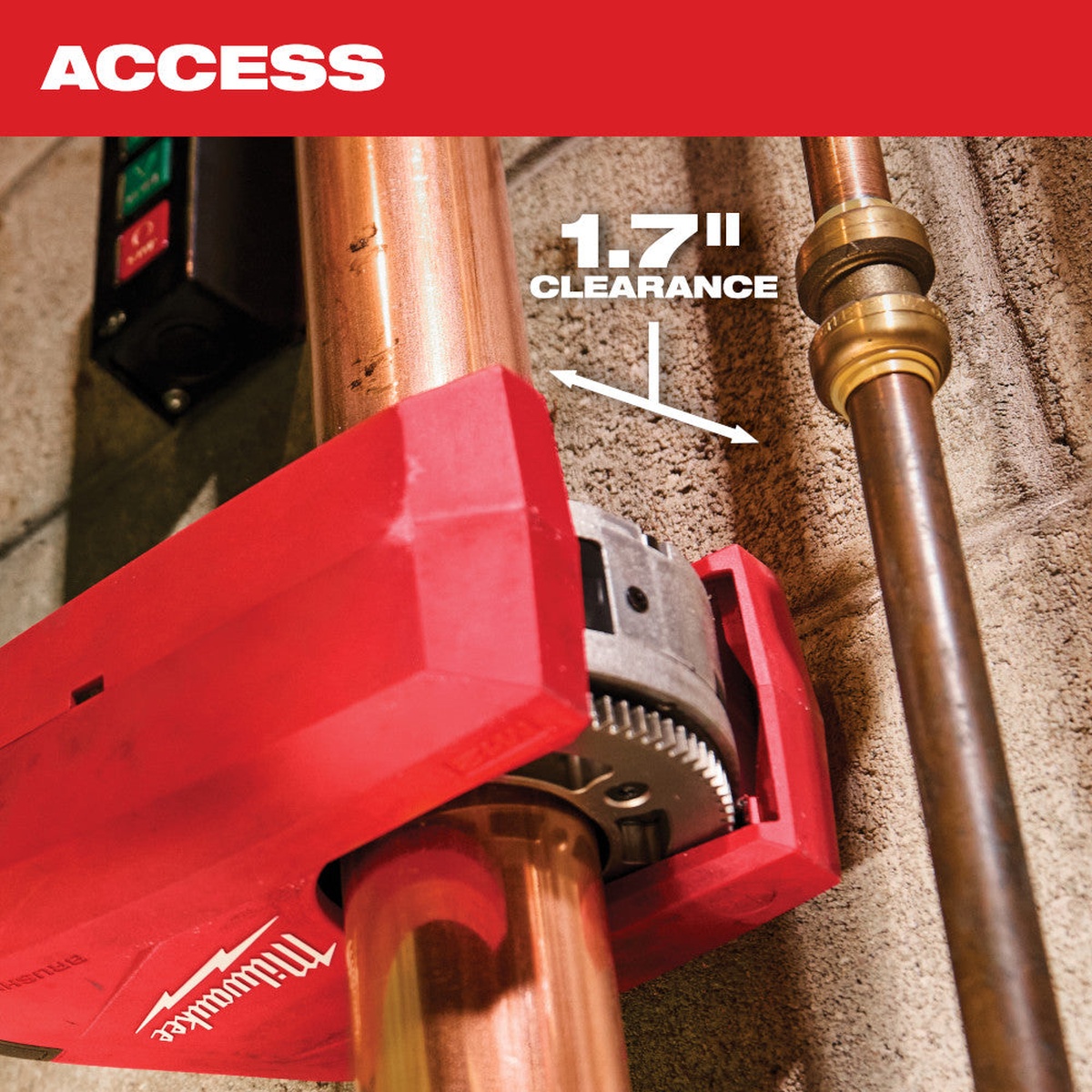Milwaukee 2479-20 M12 Brushless 1-1/4 inch to 2 inch Copper Tubing Cutter cutting installed copper pipe near a wall in a tight plumbing space with 1.7 inch clearance