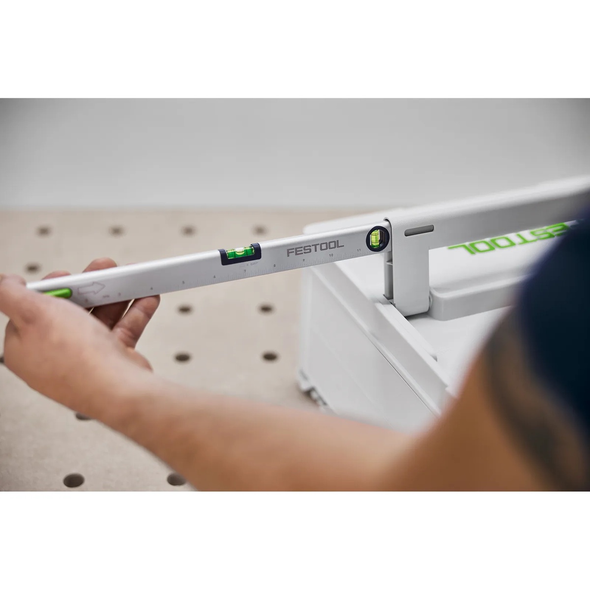Festool 577220 LEYSYS-FT1 spirit level stored in a Systainer3 handle during tool setup on a perforated workbench