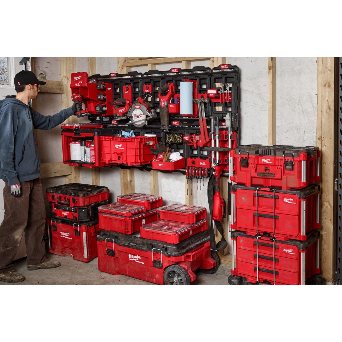 Milwaukee 48-22-8497 PACKOUT Large Wall Plate mounted in a workshop storage wall with PACKOUT tool boxes and accessories for jobsite and garage organization