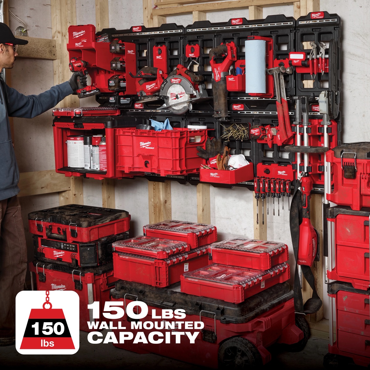 Milwaukee 48-22-8497 PACKOUT Large Wall Plate installed in a workshop wall holding PACKOUT storage, power tools, and accessories in a real garage organization setup