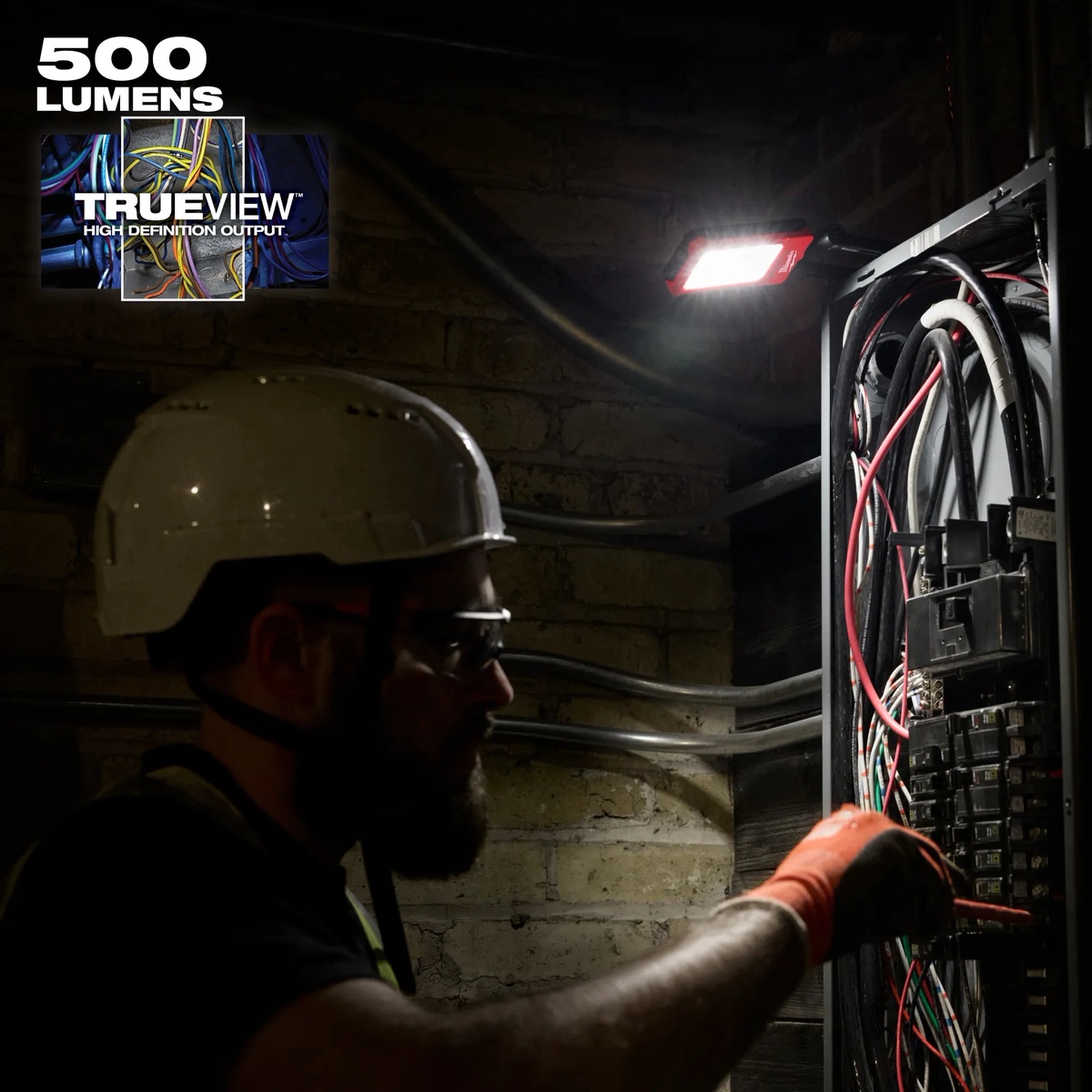 Milwaukee 2013R Rechargeable Low-Profile Magnetic Task Light mounted near an electrical panel for service and inspection work
