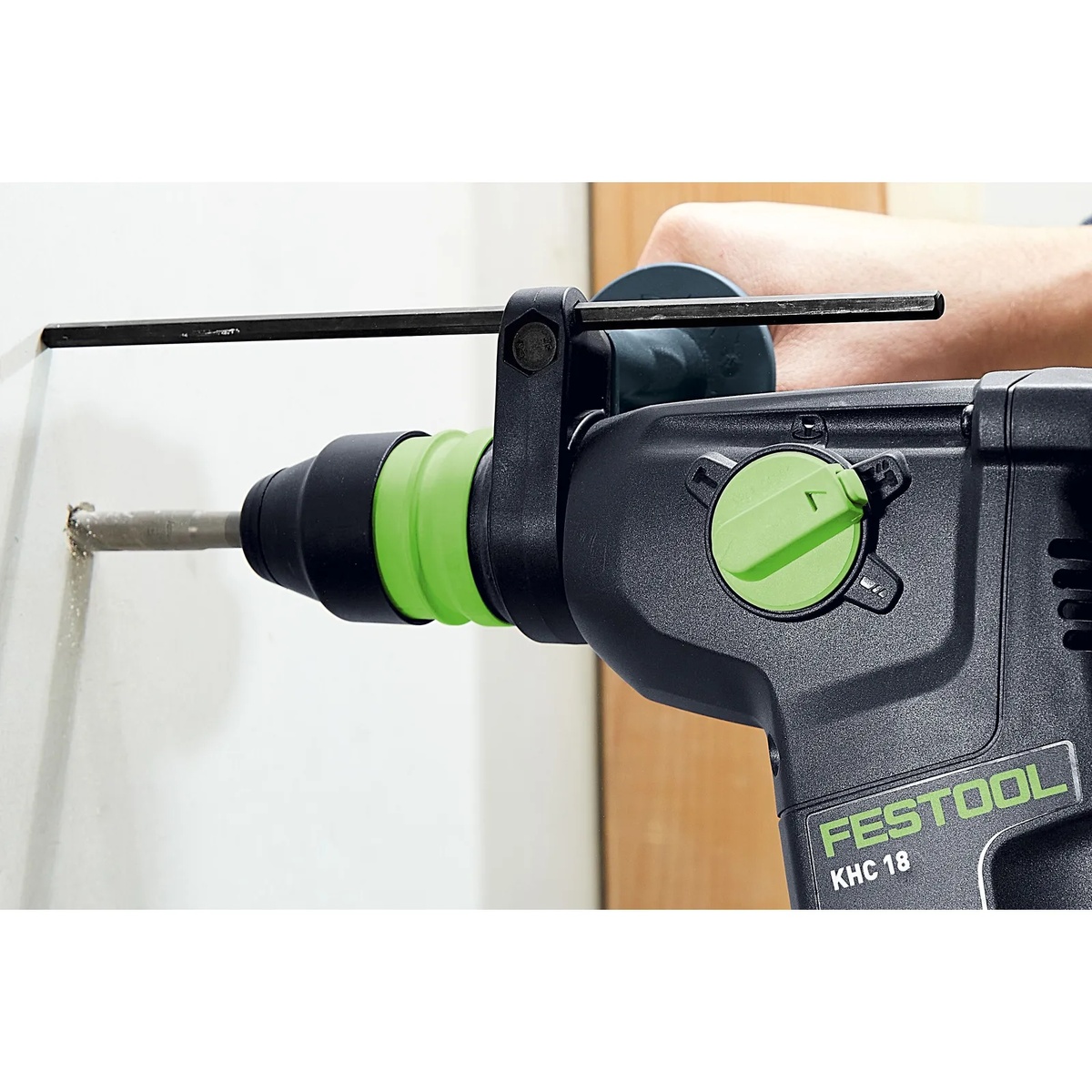 Festool KHC 18 EB-Basic Cordless Rotary Hammer Drill drilling into a wall with depth stop installed for controlled masonry drilling in an interior jobsite setting