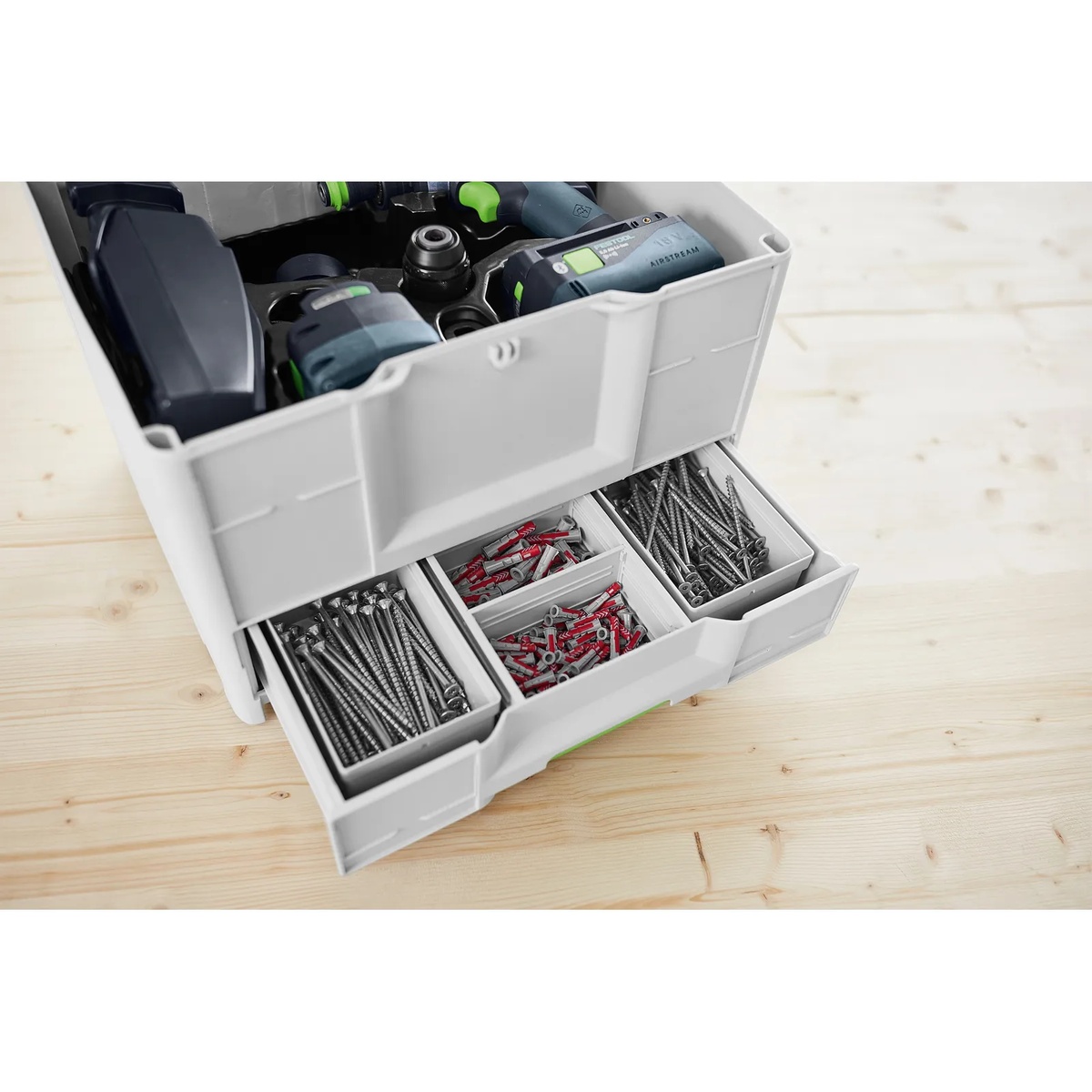Festool 577767 SYS3-COMBI M 337 Systainer opened on a workbench with power tools in the top compartment and screws and anchors organized in the lower drawer