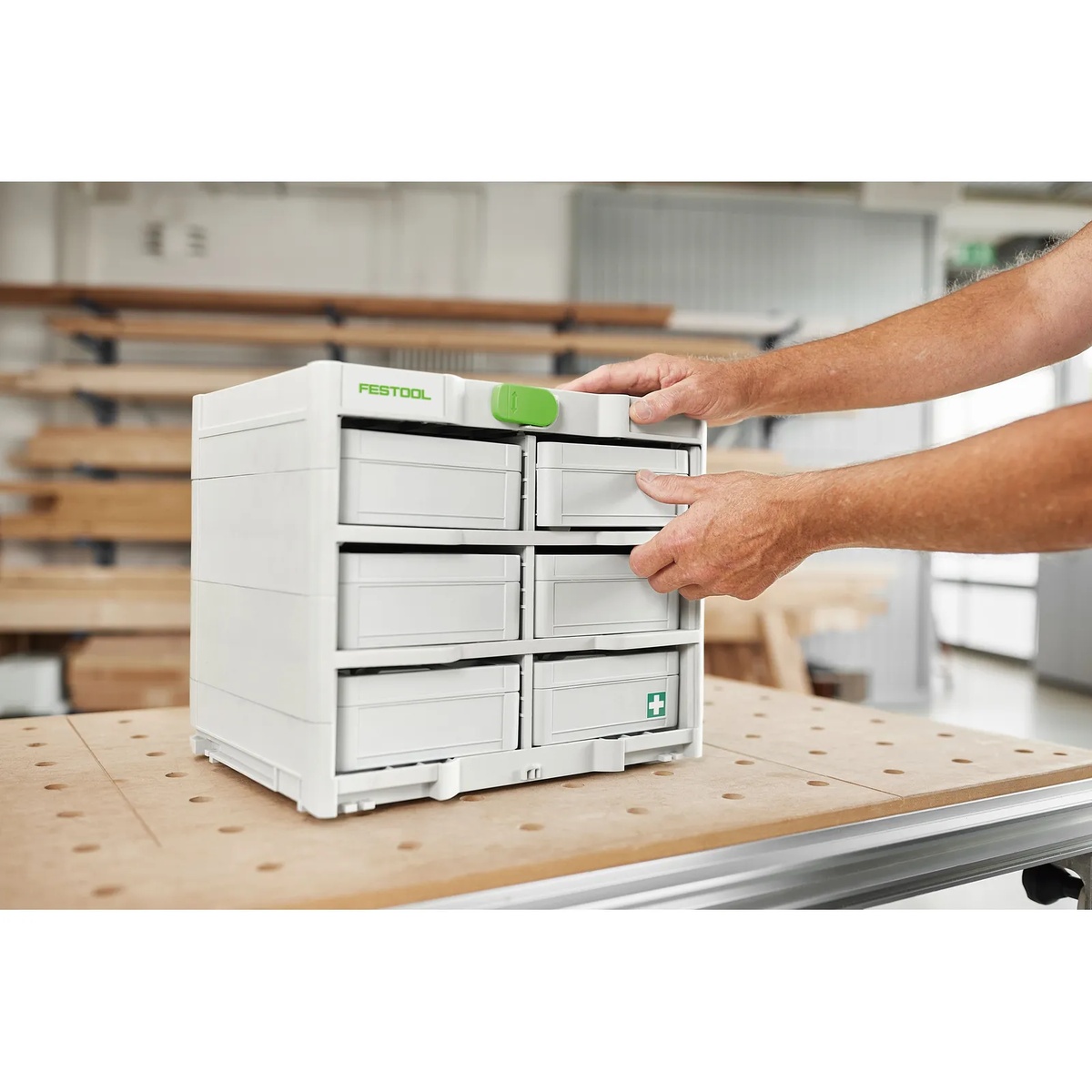 Festool 577807 SYS3-RACK 337 Systainer loaded with MINI-Systainers on a woodworking bench while a user accesses the upper tray