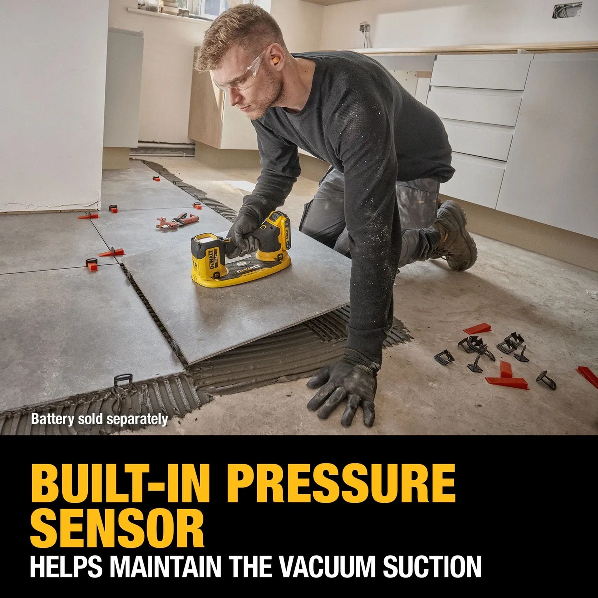 DEWALT DCE592B 20V MAX GRABO Lifter setting a large floor tile during remodeling work with built-in pressure sensor maintaining vacuum suction