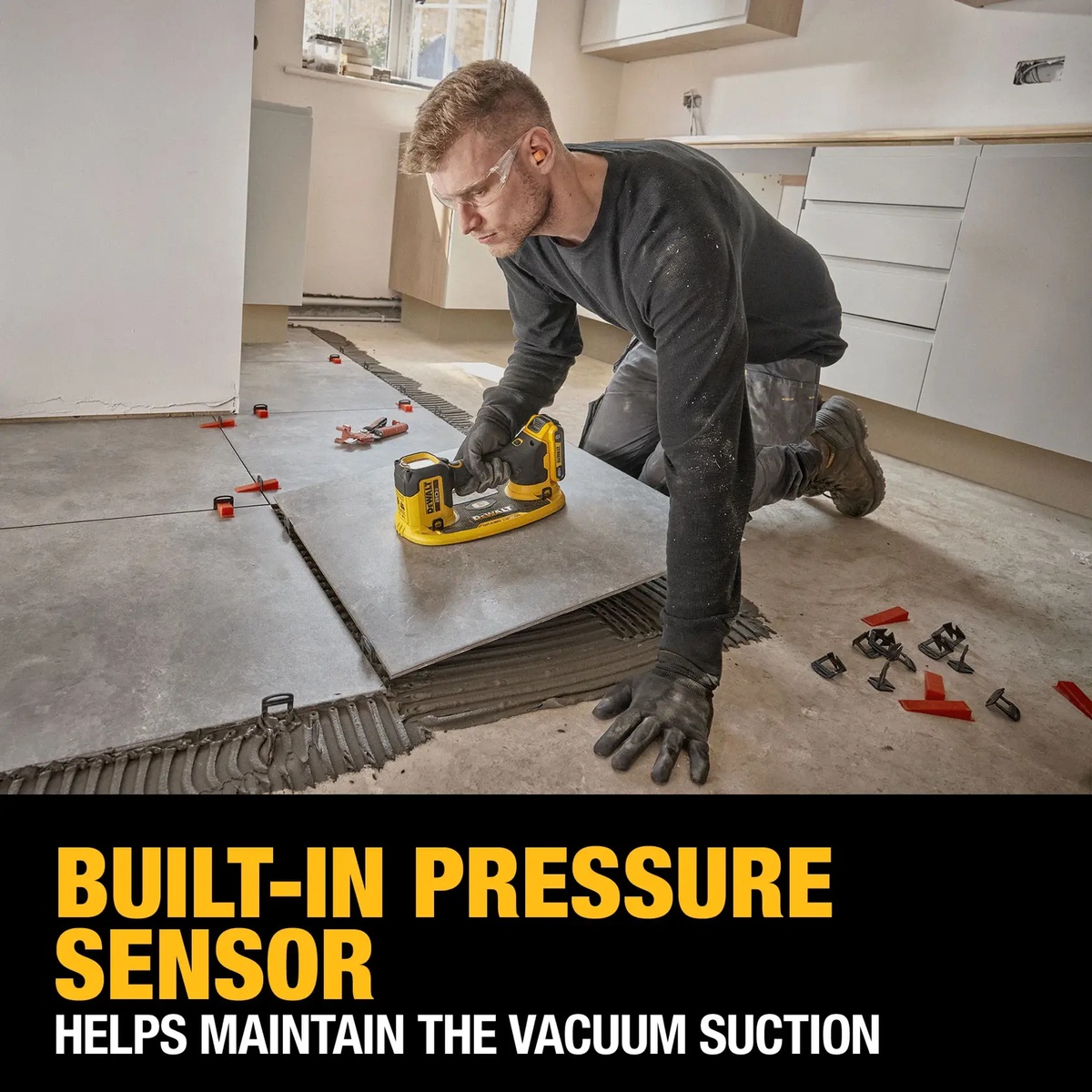 DEWALT 20V MAX GRABO Lifter Kit being used to place a large floor tile during indoor tile installation with thinset on the subfloor