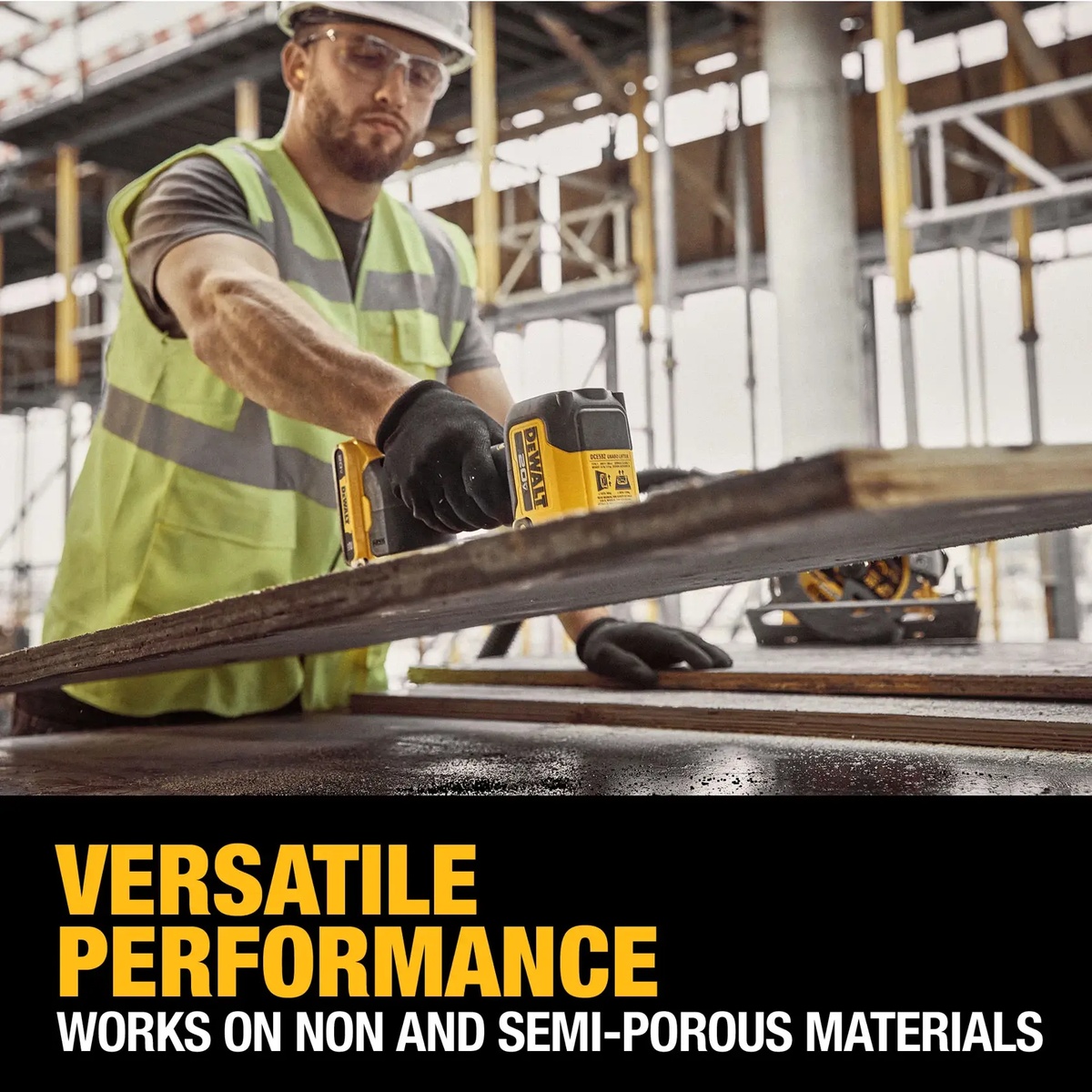 DEWALT 20V MAX GRABO Lifter Kit lifting a large wood or sheet material panel on an active construction site for panel handling and installation
