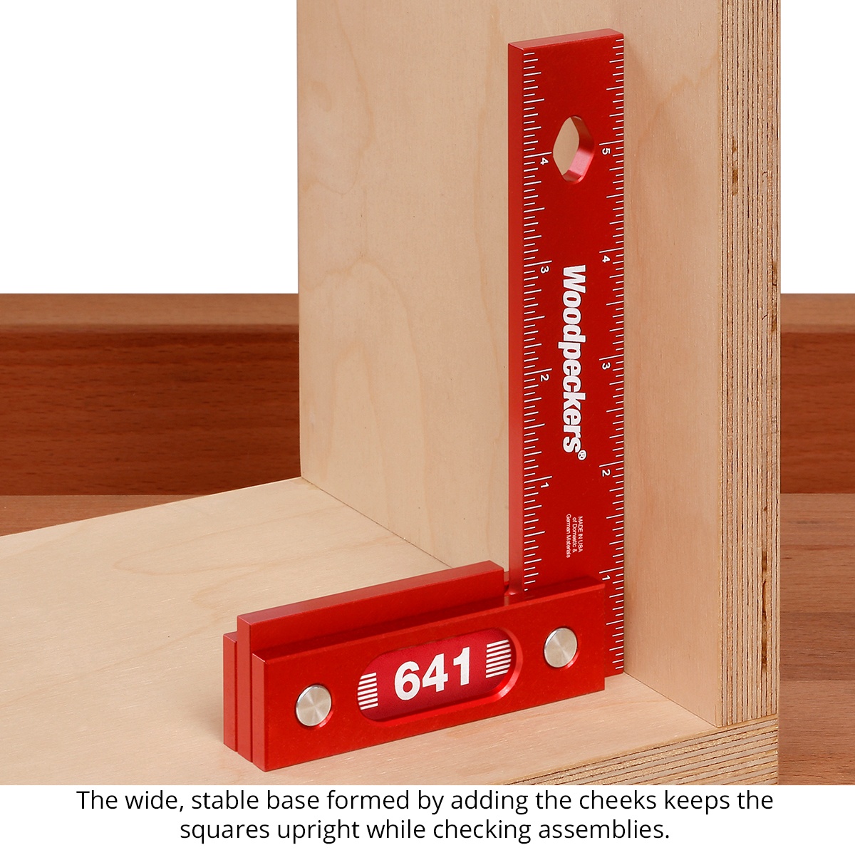 Woodpeckers 641 & 851 Precision Woodworking Squares standing upright inside a plywood cabinet corner for assembly squareness checks