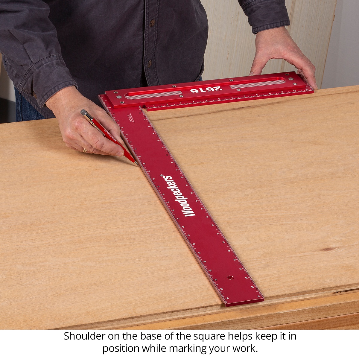 Woodpeckers Precision Woodworking Squares marking a plywood panel on a bench with the square shoulder registered against the edge