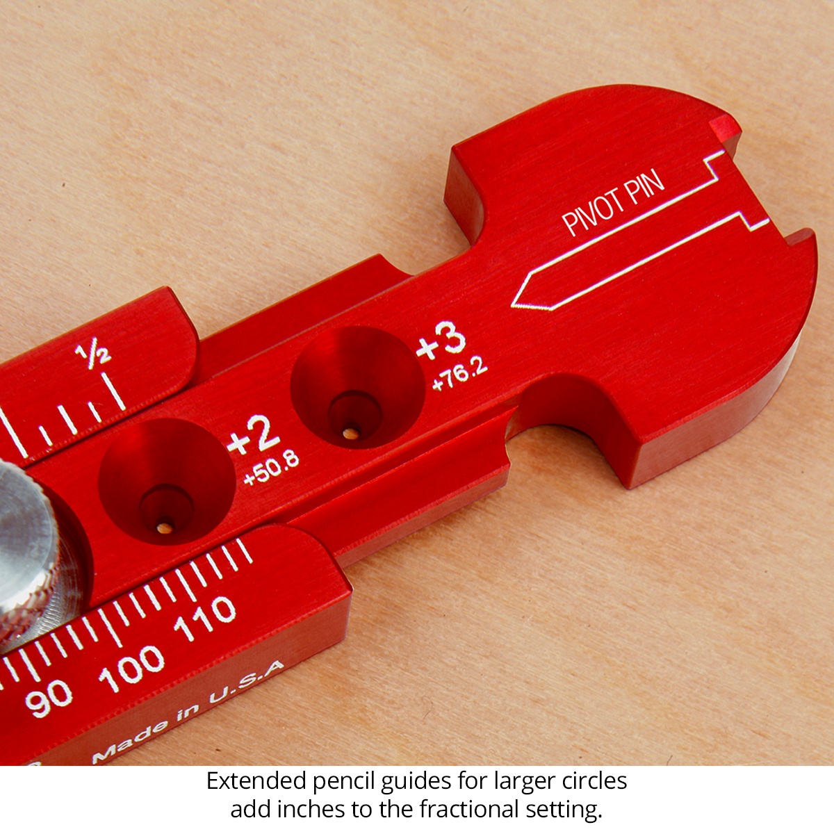 Close-up of the Woodpeckers Pocket Compass showing extended pencil guide holes and pivot pin on a woodworking bench