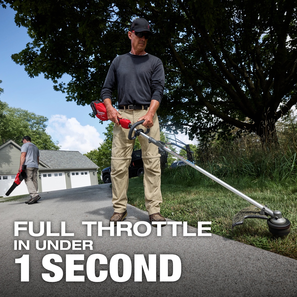Milwaukee M18 FUEL Power Head w/ QUIK-LOK trimming along a residential driveway edge with a line trimmer attachment during yard maintenance