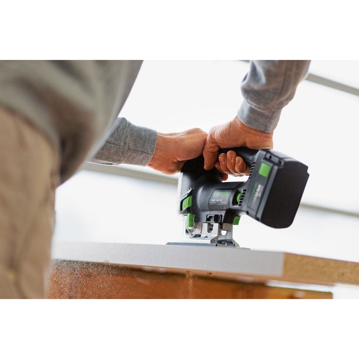 Festool PSBC 420 EB Carvex Jigsaw 4.0Ah Systainer3 Kit with Imperial Accessory Kit & 25-Piece Blade Assortment cutting a panel edge on a work surface in a real jobsite setting