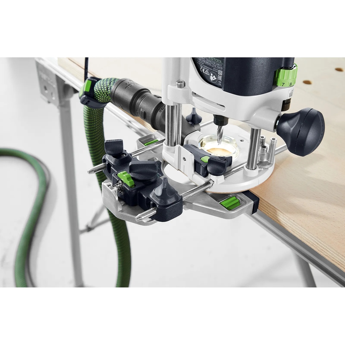 Festool OF 1010 REBQ-Plus Router using the parallel edge guide along a plywood edge for controlled groove routing with dust extraction connected