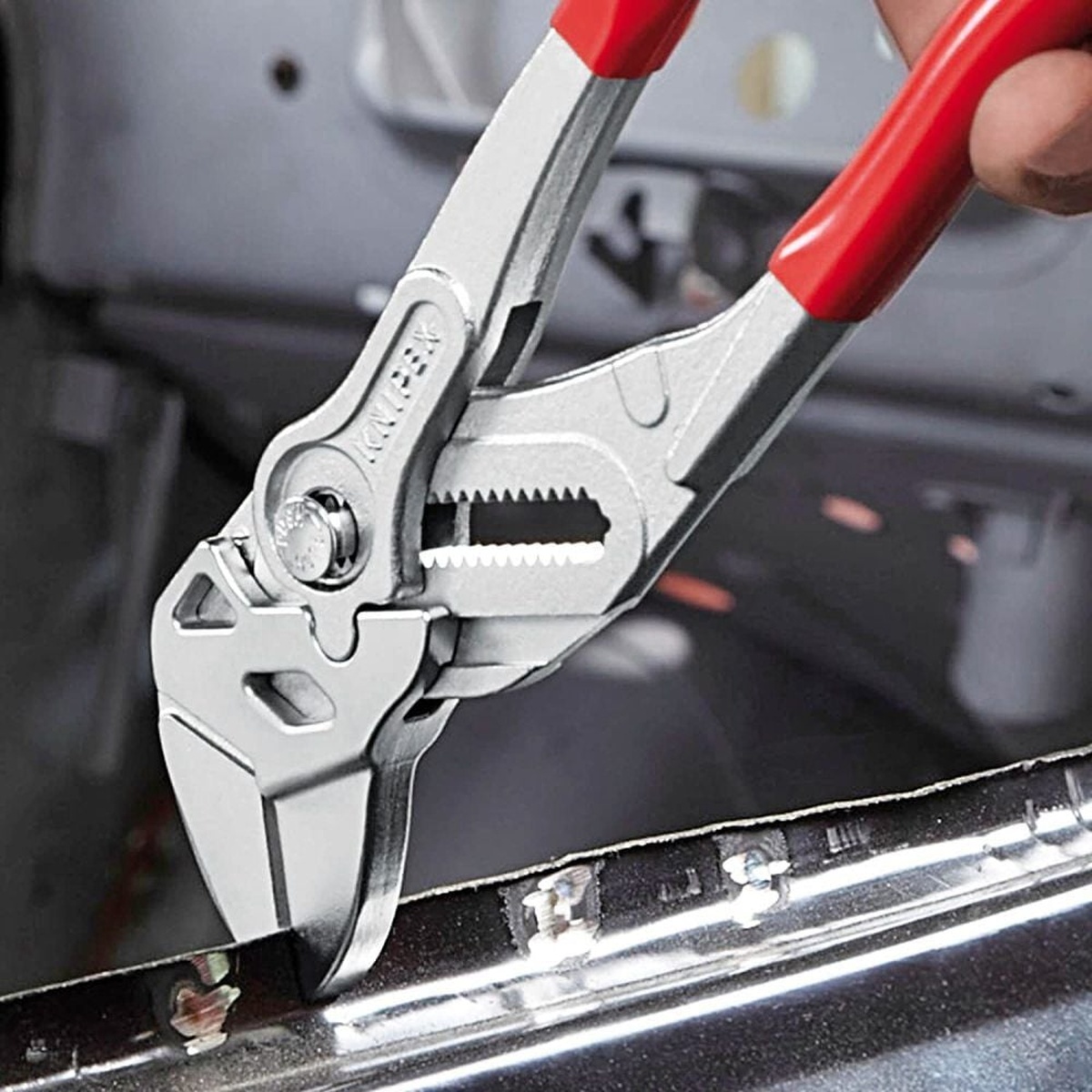 Knipex 86 03 250 SBA 10 in. Pliers Wrench gripping a chrome fitting during installation work in a tight mechanical space
