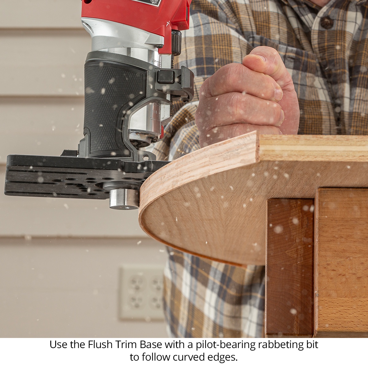 Woodpeckers Flush Trim Base following a curved plywood edge with a router during woodworking trim work