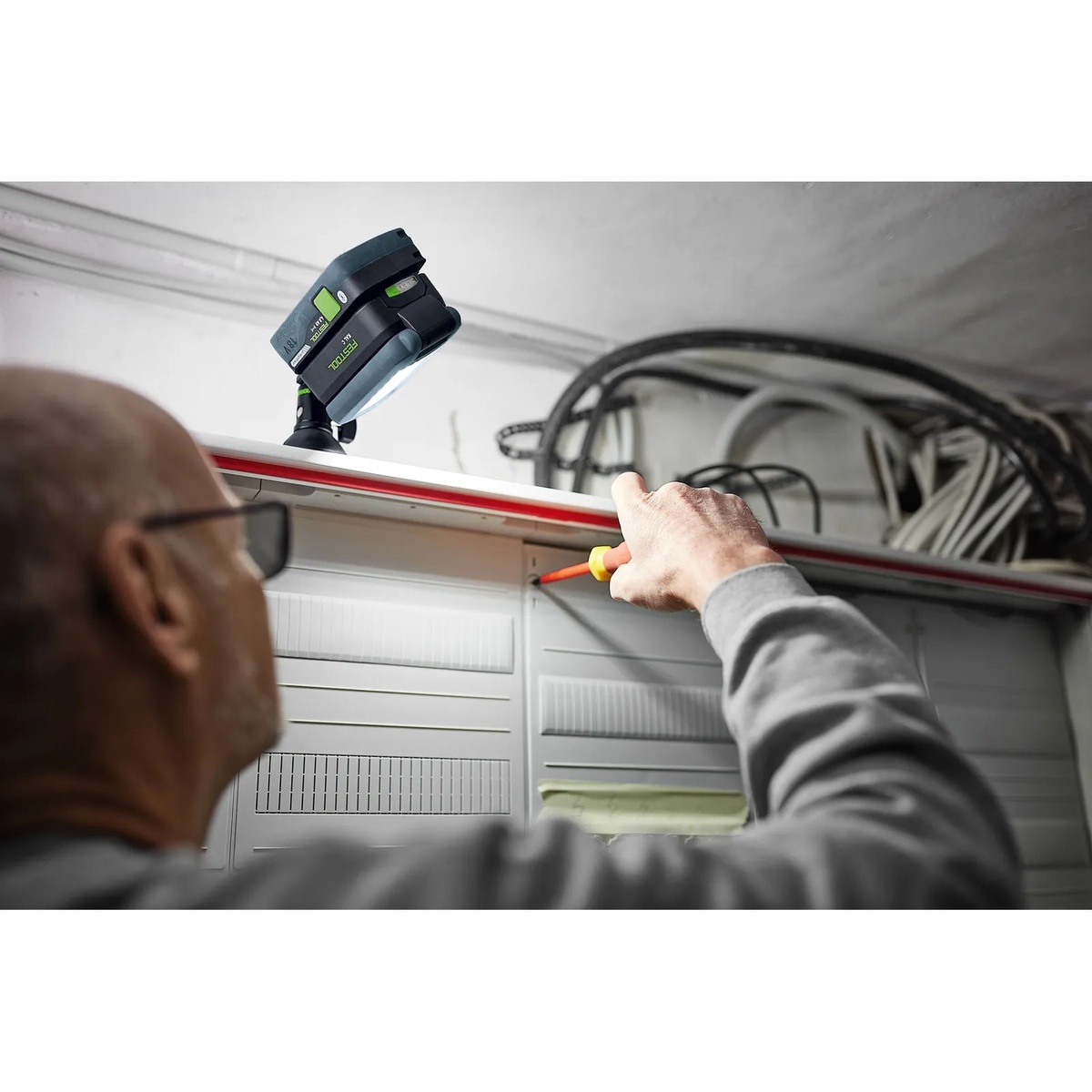 Festool 578128 SYSLITE KAL C Cordless 1200-Lumen Task LED Light mounted overhead to light an electrical work area during service and installation work