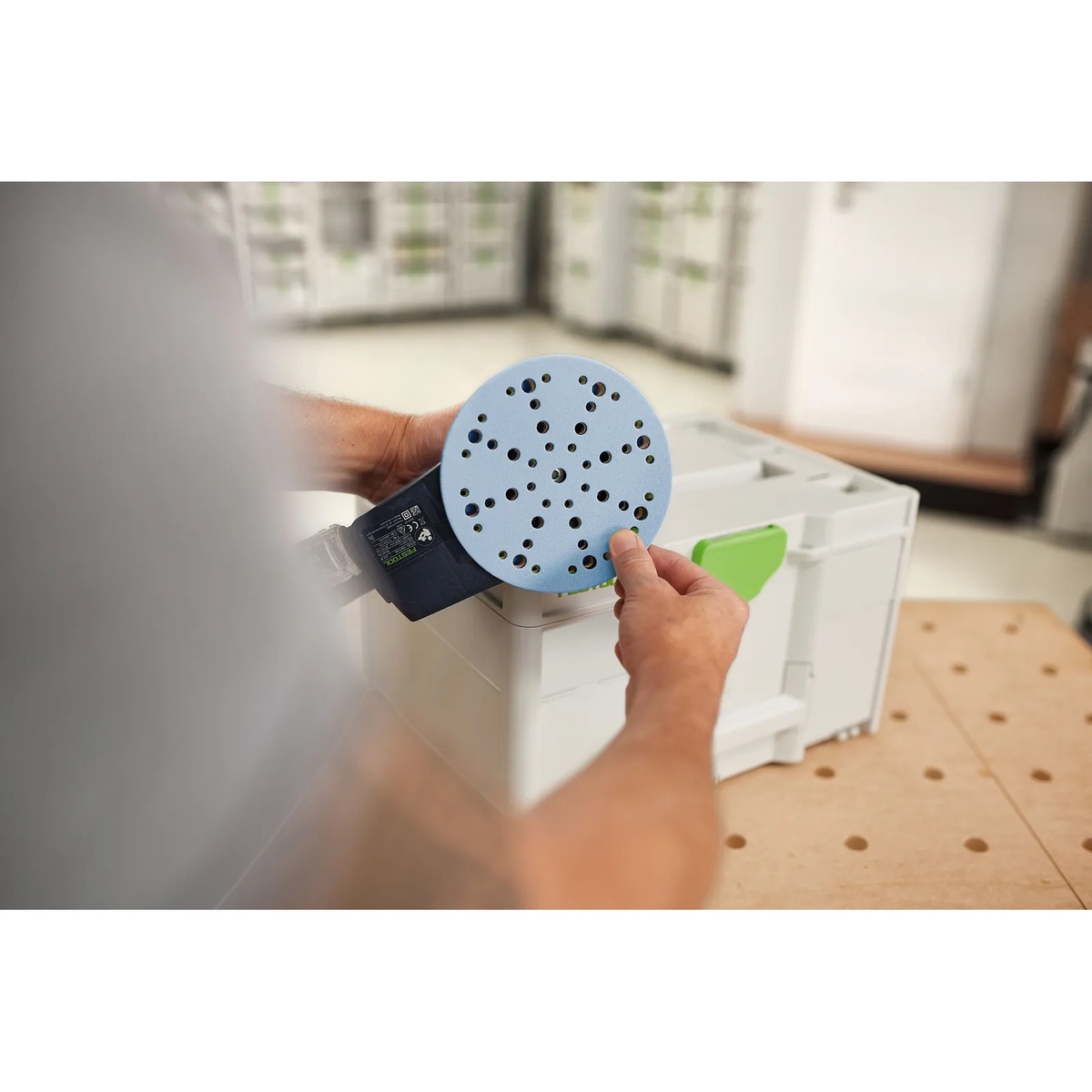Festool 578192 Granat D150 Abrasives 120-Piece Value Set Systainer3 sanding disc being fitted to a 150 mm sander pad for dust-controlled finish sanding