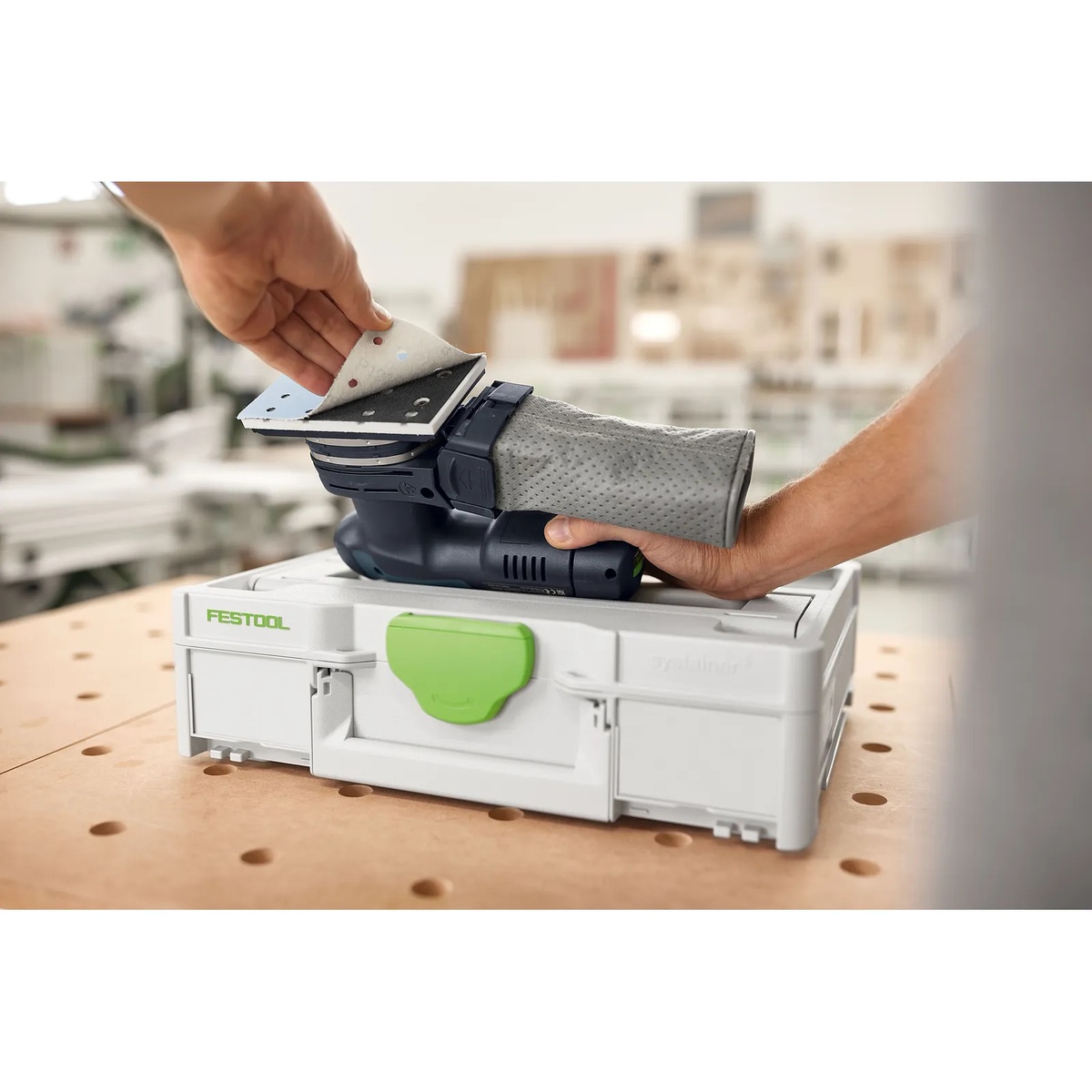 Festool Granat 80x133 abrasive sheet being removed from a compatible Festool sheet sander during finish sanding setup in a woodworking shop